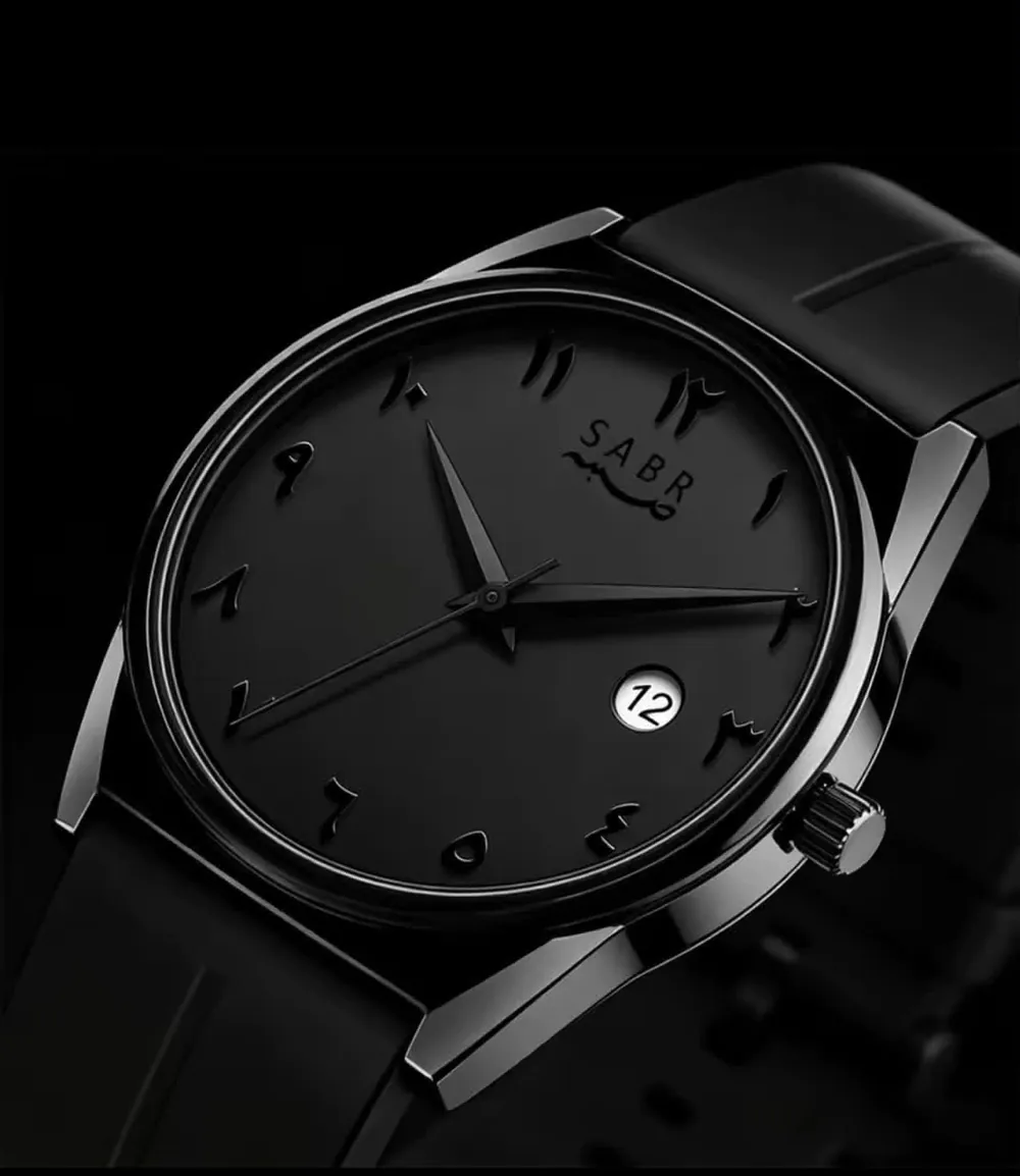 Matte black watch close-up with raised Arabic numerals